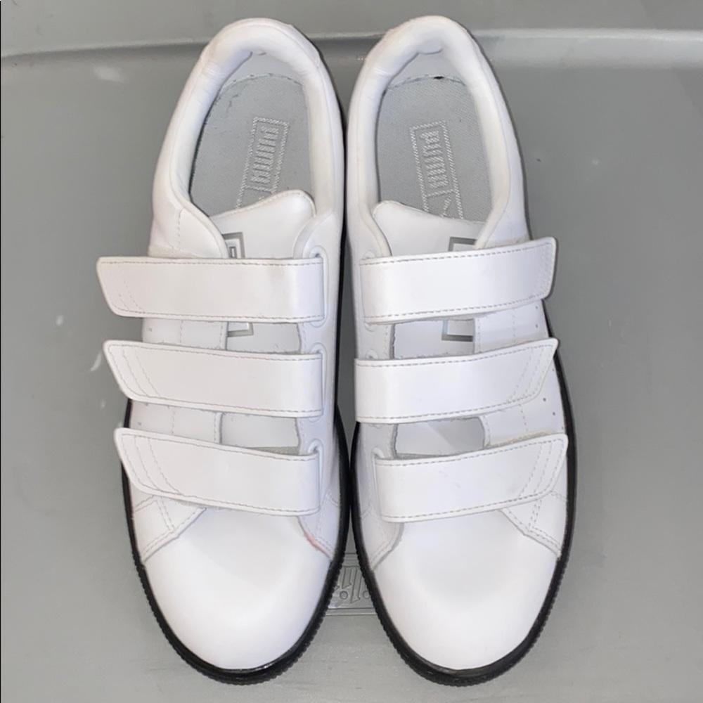 White leather strap puma shoes.